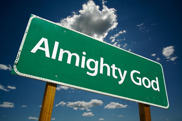 Almighty god green road sign over dramatic clouds and sky