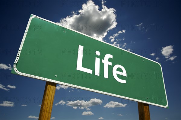 Life road sign with dramatic clouds and sky