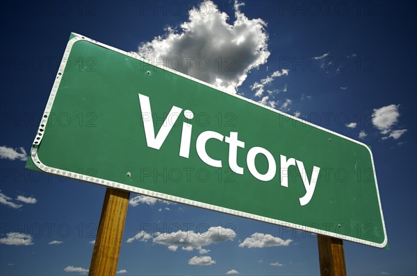 Victory road sign with dramatic clouds and sky