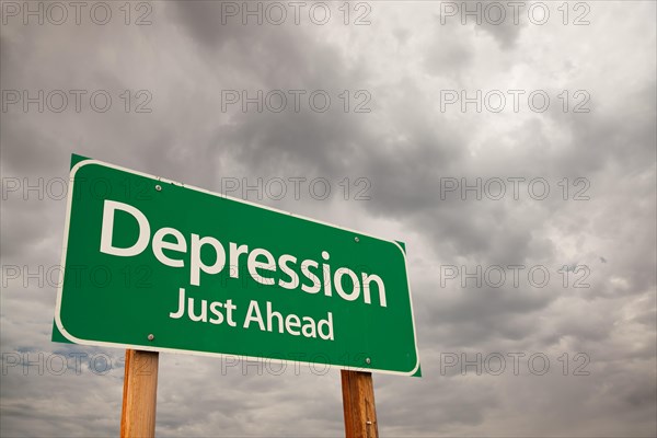 Depression just ahead green road sign with dramatic storm clouds and sky