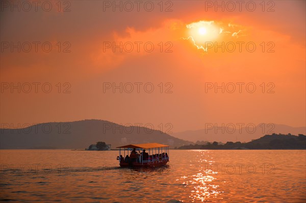 Tourist boat in lake Pichola on sunset. Udaipur