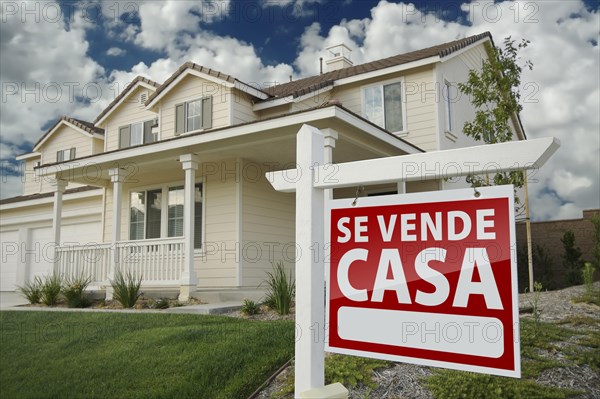 Home for sale real estate sign in front of new house