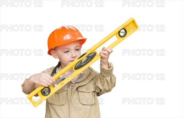 Cute young boy dressed as contractor holding level