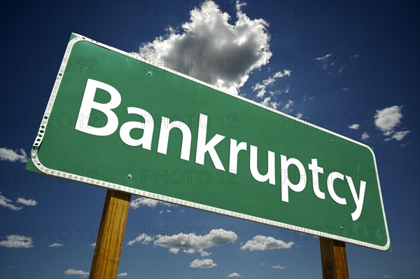 Bankruptcy road sign with dramatic clouds and sky