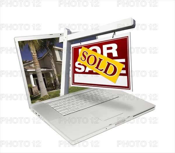 Sold home for sale sign & new home on laptop isolated on a white background