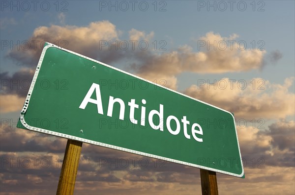 Antidote green road sign with dramatic clouds and sky