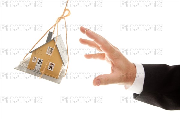 Swinging house and business man's hand reaching or pushing isolated on a white background