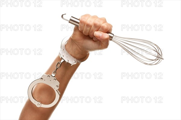 Handcuffed woman holding egg beater in the air isolated on a white background