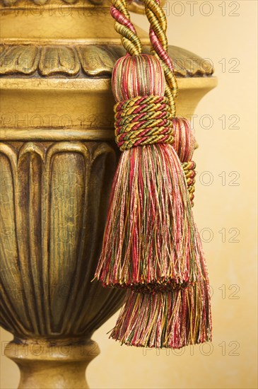 Lamp on table with ornate hanging tassel