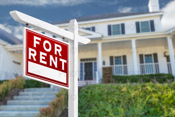 Left facing for rent real estate sign in front of house