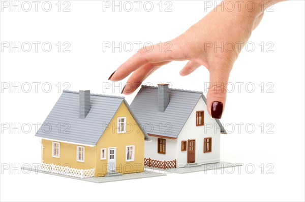 Female hand reaching for house isolated on a white background