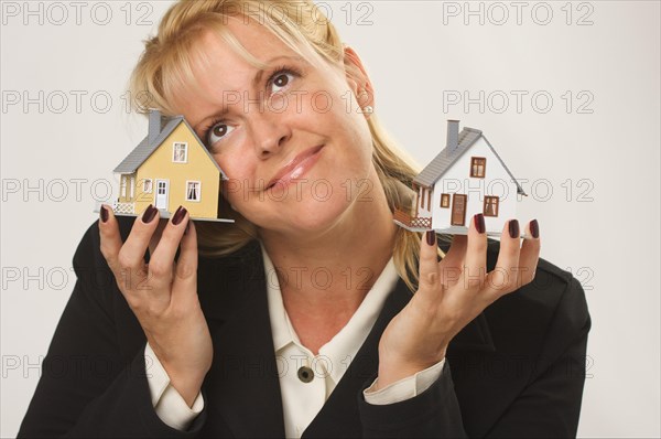 Female dreaming while holding two houses