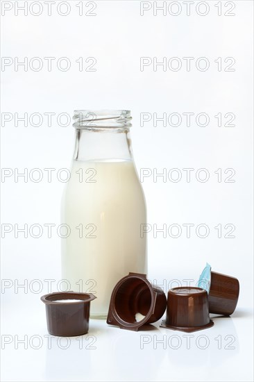 A bottle of milk and milk in portion pack