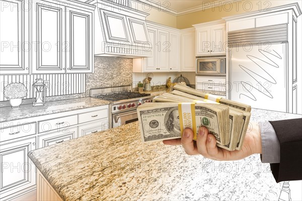 Hand handing stacks of money over custom kitchen design drawing and photo combination