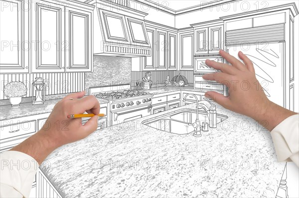 Male hands sketching with pencil the outline of a beautiful custom kitchen