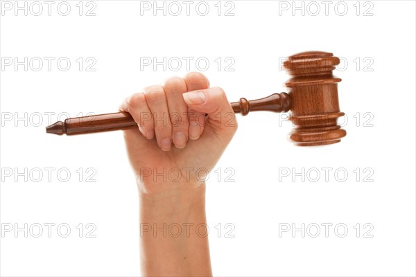 Woman holding wooden gavel in her fist isolated on a white background