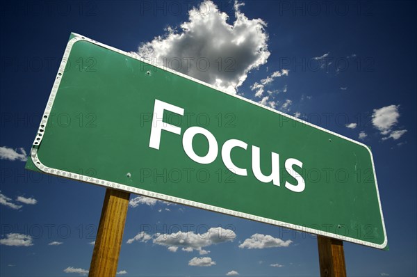 Focus road sign with dramatic blue sky and clouds