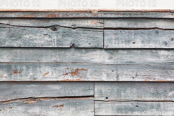 Weathered wood panel wall with peeling paint textured background