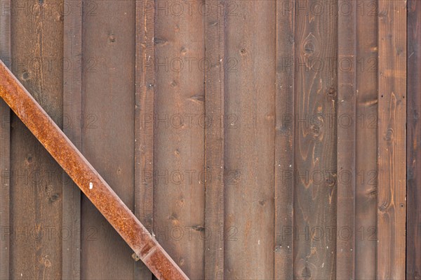 Wooden wall with rusty metal beam background