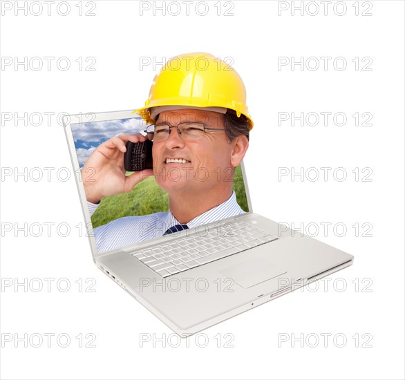Laptop and man with hard hat on cell phone extruding the screen