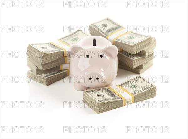 Pink piggy bank with stacks of hundreds of dollars isolated on a white background