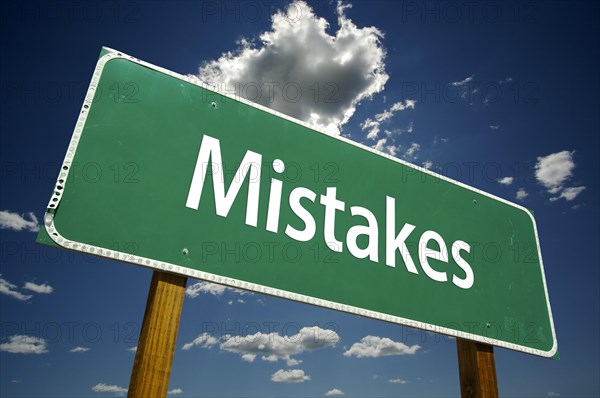 Mistakes road sign with dramatic clouds and sky