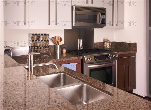 Modern apartment kitchen with brushed aluminum appliances