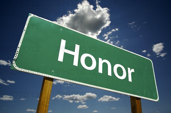 Honor road sign with dramatic clouds and sky