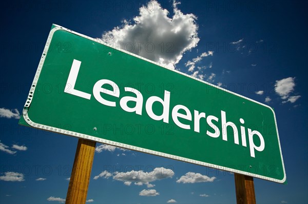 Leadership road sign with dramatic clouds and sky