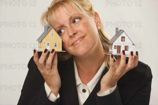 Female dreaming while holding two houses