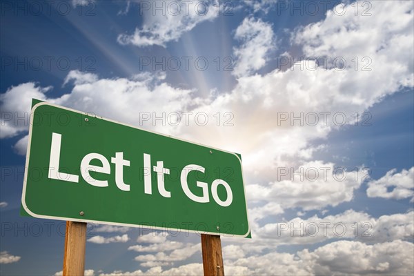 Let it go green road sign with dramatic clouds and sky