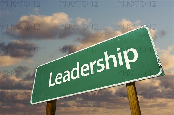 Leadership green road sign with dramatic blue sky and clouds