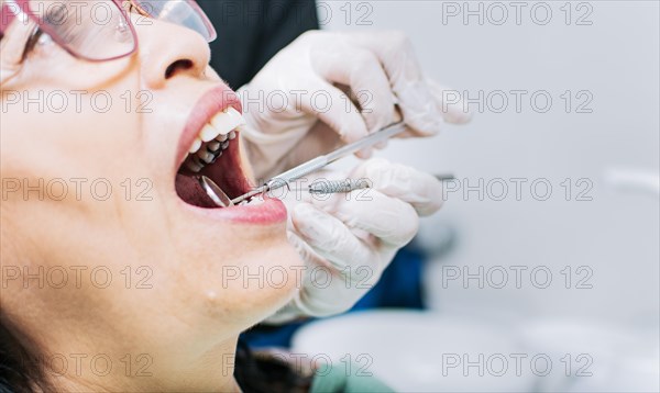 Close up of patient checked by dentist