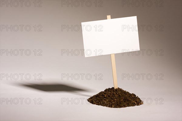 Blank white sign in mount of dirt ready for your own message