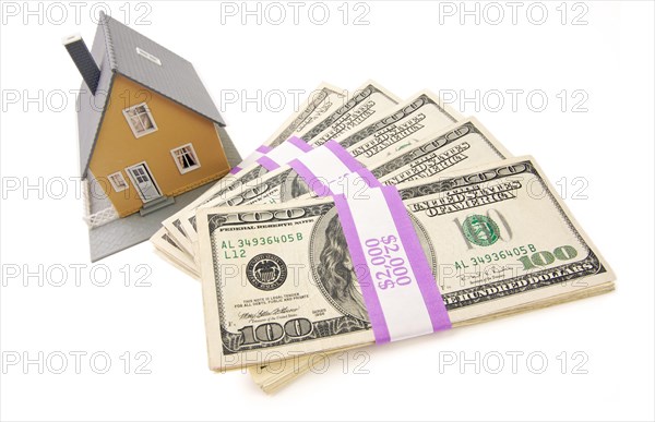 Home and stacks of money isolated on a white background