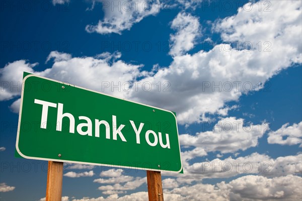 Thank you green road sign with copy room over the dramatic clouds and sky