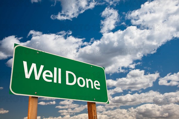 Well done green road sign with dramatic clouds and sky