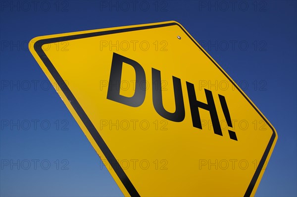 Yellow duh! road sign against a dramatic blue sky with clipping path