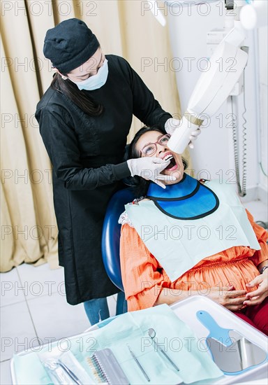 Female dentist doing dental x-ray