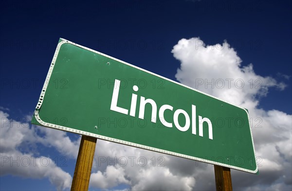 Lincoln road sign with dramatic blue sky and clouds