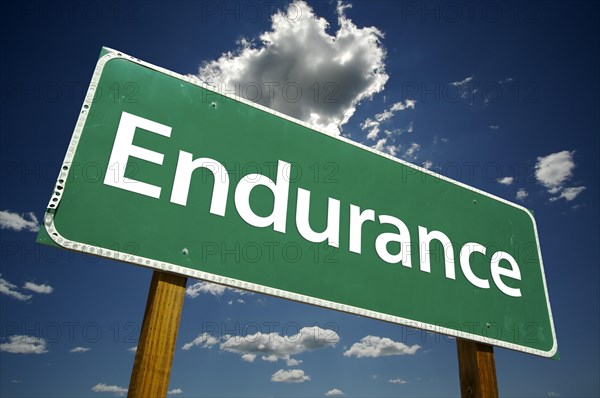 Endurance road sign with dramatic clouds and sky