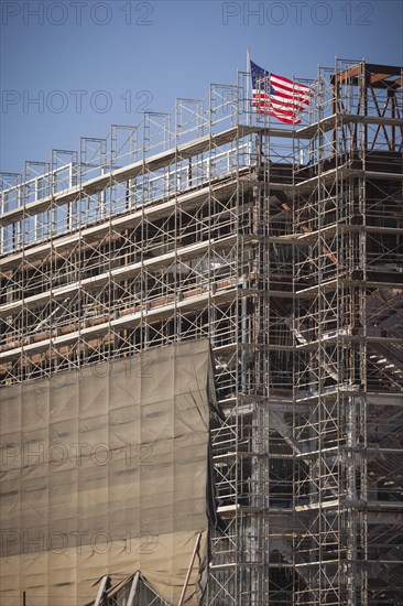 Majestic american flag flying on top of new building construction