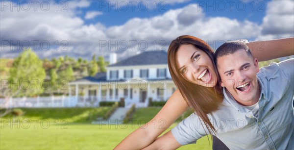 Playful young military couple outside A beautiful new home