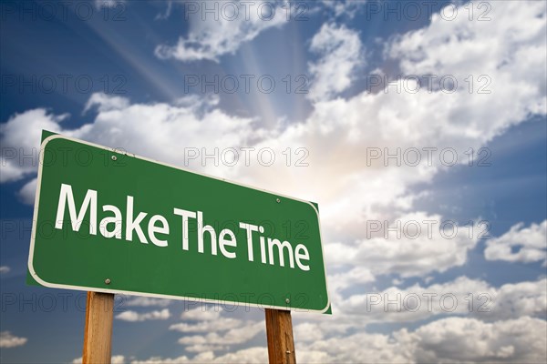 Make the time green road sign with dramatic clouds