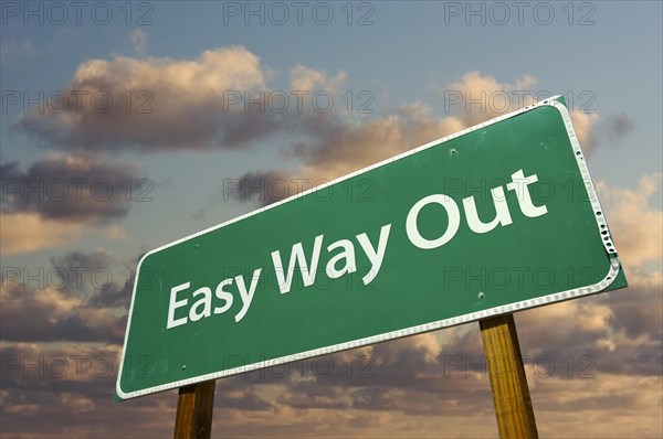 Easy way out green road sign with dramatic clouds and sky