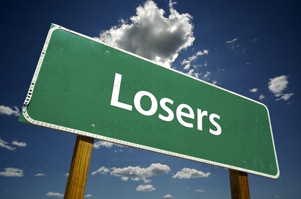 Losers green road sign with dramatic clouds and sky