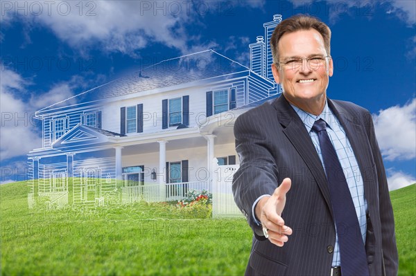 Smiling male agent reaching for hand shake in front of ghosted new house
