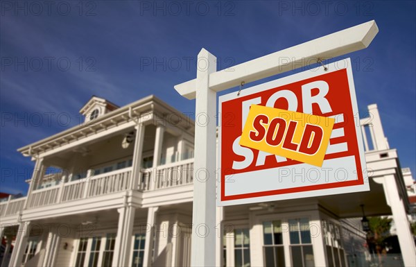 Sold home for sale sign in front of beautiful new house