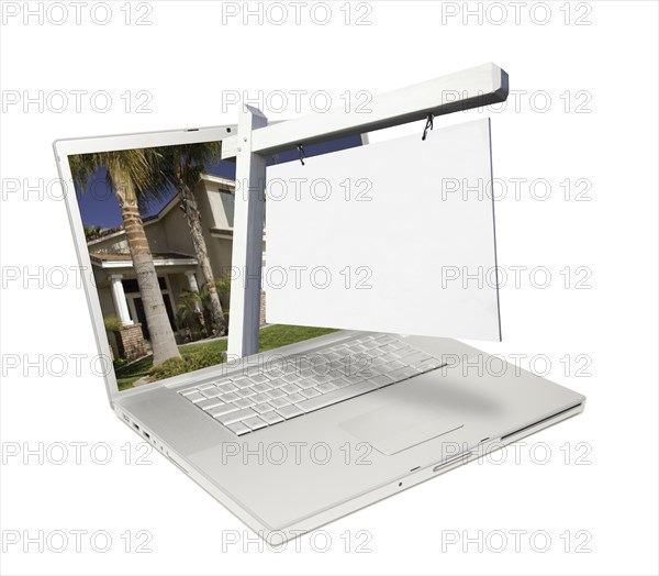 Blank real estate sign & laptop isolated on a white background