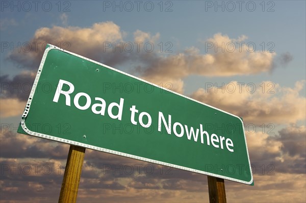 Road to nowhere green road sign with dramatic clouds and sky